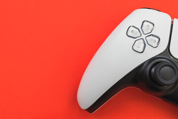 Video games white gaming controller isolated on red color background top view © Tom Eversley