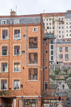 "Mur des Canuts" (1987 - 1997) in the Croix-Rousse district. The huge mural is a realistic painting of a Lyon scene, part of the "Cite de Creation". LYON, FRANCE. July 26, 2020.