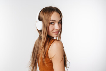 Happy beautiful woman smiling while listening music with headphones