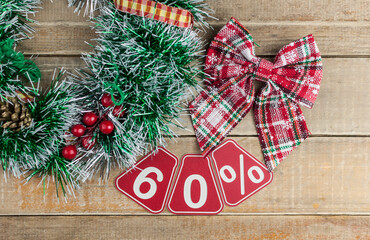 Big sales 60%, sixty percents with Christmas wreath on a old barn plank background, top view, copy space, flat layout. Christmas big sale.