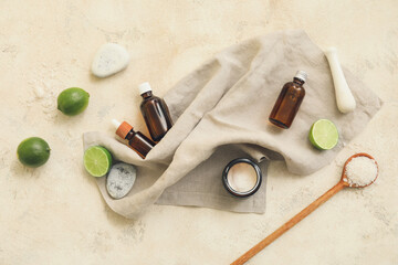 Composition of bottles with natural citrus cosmetics on light background