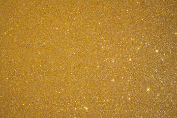 Trendy color Fortuna gold background with glitter and feather. Christmas background.