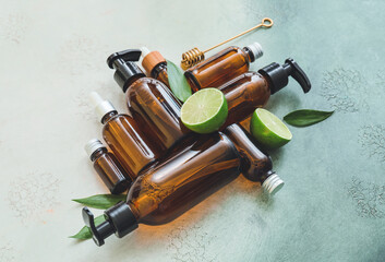 Composition of bottles with natural cosmetics on color background