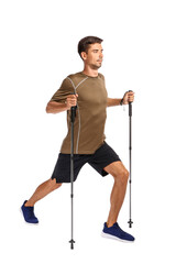 Fototapeta premium Young man with walking poles on white background