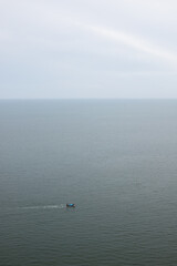 Obraz premium seascape sky ocean and mini fishing boat