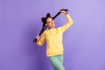 Photo of optimistic cool lady touch hair wear yellow sweater trousers isolated on lilac color background