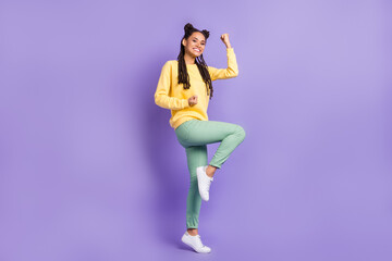 Fototapeta na wymiar Full size photo of hooray nice lady dance wear yellow sweater trousers sneakers isolated on lilac color background