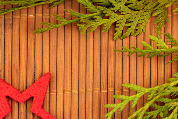 christmas decoration on wooden background with green branch and red star. Flat lay, top view, copy...