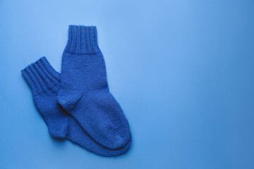 Warm socks on color background