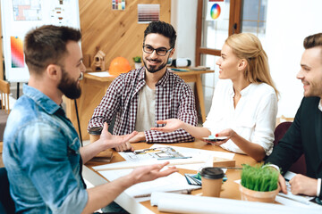 People sit at the table and discuss the project.