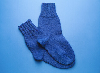 Warm socks on color background