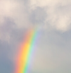 Rainbow in the sky against the background of clouds.