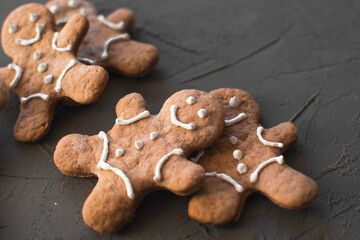 ginger cookies with frosting in the form of a smile on a gray background. traditional sweets for Christmas. Rado cookies with spices (cinnamon and star anise)