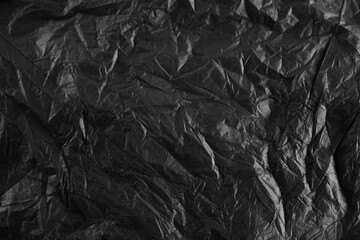 Background with Black crumpled sheet of paper with vignetting.