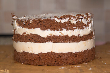 chocolate cake covered with crumbs from biscuits in the workplace. sweets. homemade cake for a holiday