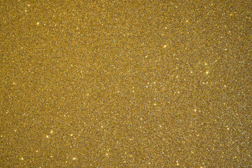 Trendy color Fortuna gold background with glitter and feather. Christmas background.