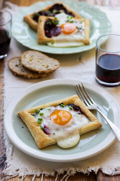 Puff pastry mini tarts with beetroot, egg and chieve, blach pepper, bread, red wine