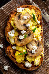 Scrambled egg with mushrooms and cottage cheese on toast. vertical image. Food recipe background. Close up