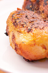 Golden crispy roasted chicken legs with skin macro close up shot