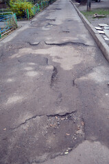 Road of Ukrainian democracy. Poor condition of the road surface. Hole in the asphalt, risk of movement by car, bad asphalt, dangerous road, potholes in asphalt. Kiev , Ukraine