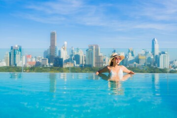Naklejka premium Portrait beautiful young asian woman smile relax leisure around outdoor swimming pool