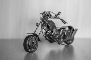 A motorcycle model assembled from household items. A piece of pipe, wire, nuts, etc.