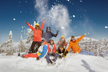 Group of friends in colorful clothes at ski resort