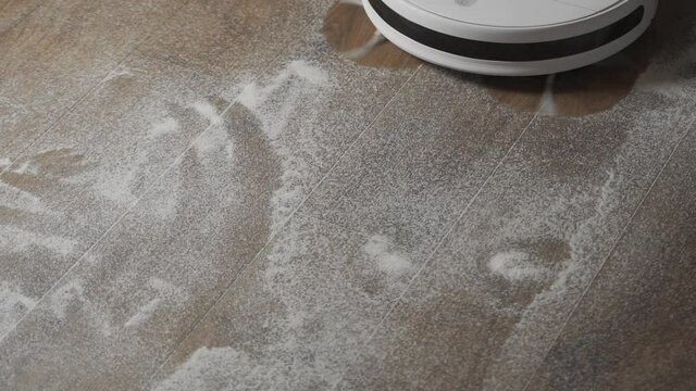 Modern robot vacuum cleaner working in the house kitchen