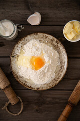 egg,  flour and butter, sugar on wooden background.
