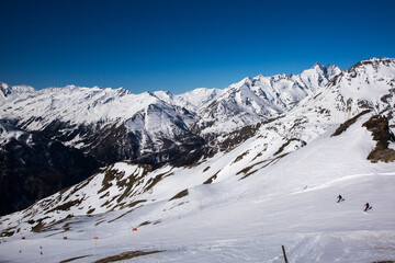 Fototapeta na wymiar Winter landscape - Panorama of the ski resort with ski slopes. Alps. Austria.