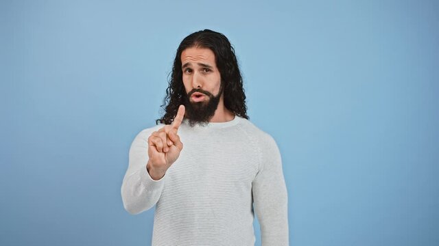 Rejection and prohibition concept. Studio shot of serious bearded guy gesturing no with forefinger and shaking head