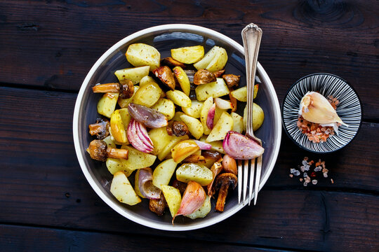 Roasted potato, mushroom and onion in plate