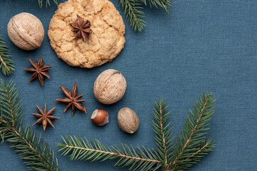 Christmas composition. Pine cones, fir branches on blue fabric background. Flat lay, top view. Copy space.