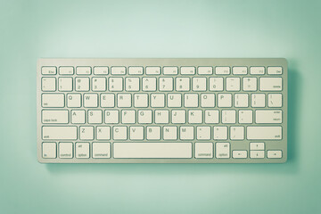 White Portable Computer Keyboard Keys or Keyboard Button on Blue Pastel Minimalist Background at Center Frame in Vintage Tone