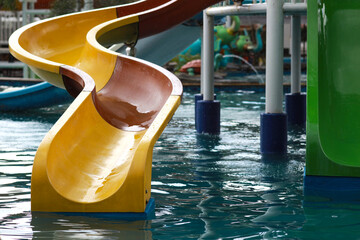 Colored plastic water slides with pool in outdoor aqua park