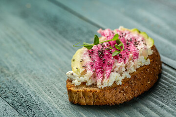 Healthy breakfast toasts from sliced watermelon radish with chinese daikon, cottage cheese and microgreen. banner, catering menu recipe place for text, top view