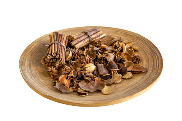 Top view of dried wood pieces in round wooden plate..