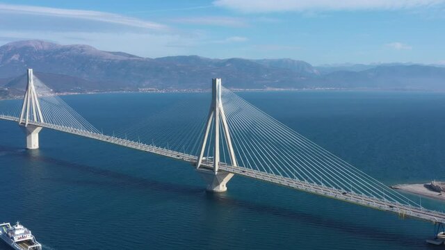 
Drone video. Cable suspension bridge of Rio - Antirio Harilaos Trikoupis. Corinthian Gulf, mainland Greece to Peloponnese, Patras. Ferry crossing. 