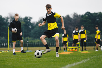 Young Soccer Players on Trainin Session. Group of Youth Football Team Members Kicking Ball on Pre-match Practice Unit. Soccer Boys With Young Coach