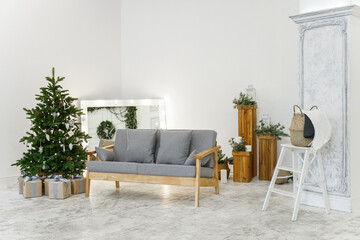 White studio with christmas tree and sofa
