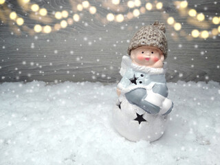 winter background with angel toy decor and snow