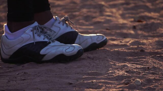 Footage Slow Motion: A close-up of baseball shoes dealing with the surface of the game field