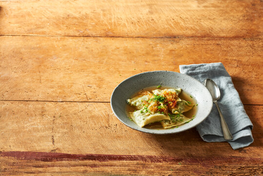 Swabian spinach ravioli with bacon and onions in stock