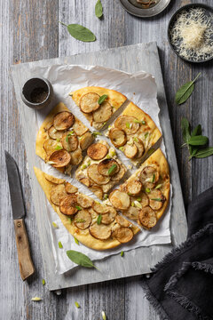 Pizza bianca with potatoes, sage, spring onions, parmesan and anchovies