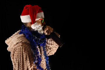Bad crazy Santa in sunglasses and foam beard drinks alcohol