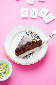 A slice of crazy cake (chocolate cake with colourful sprinkles)
