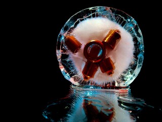 metal nozzles frozen in ice, glowing in ice in creative and abstract photography