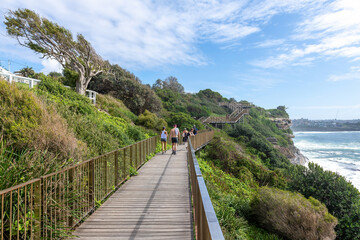 Sydney, Australia - People walking on the Coogee to Bondi coastal walk. This famous coastal walk extends for six km in Sydney's eastern suburbs. The walk features many stunning views.