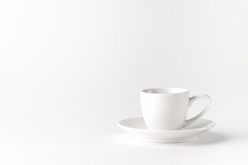 White coffee cup and a saucer on a white background.