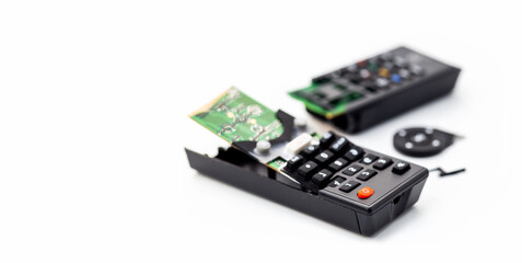 broken remote control, smashed, broken and obsolete television control. technology used, technological waste